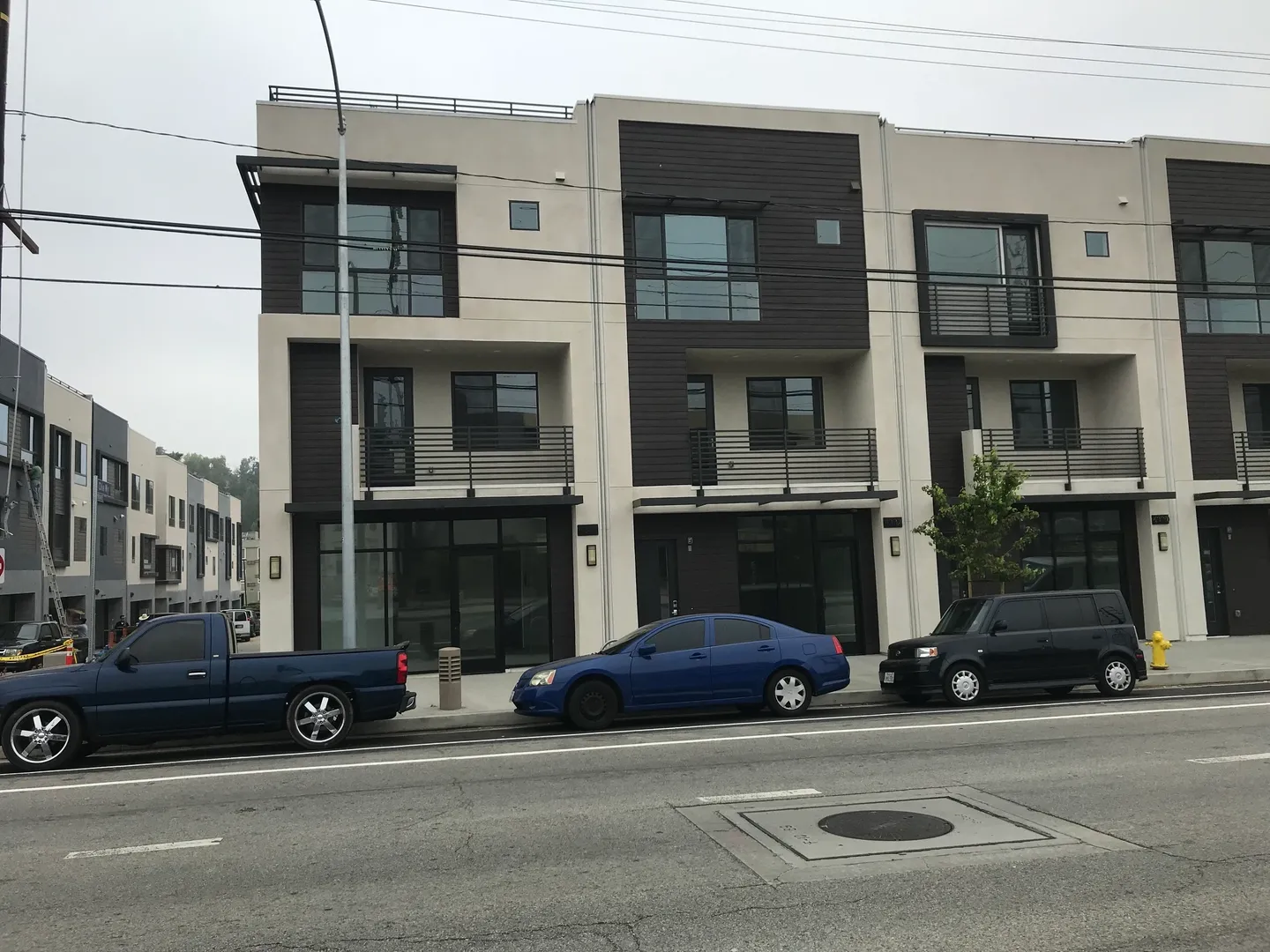 Three cars parked in front of a building