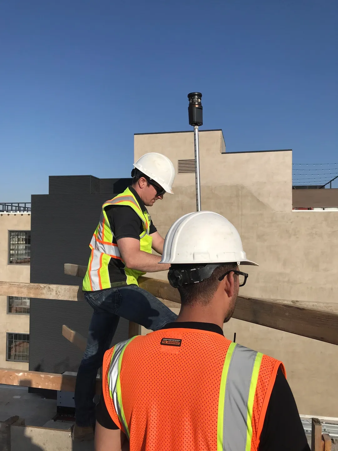 Two men wearing white hats working