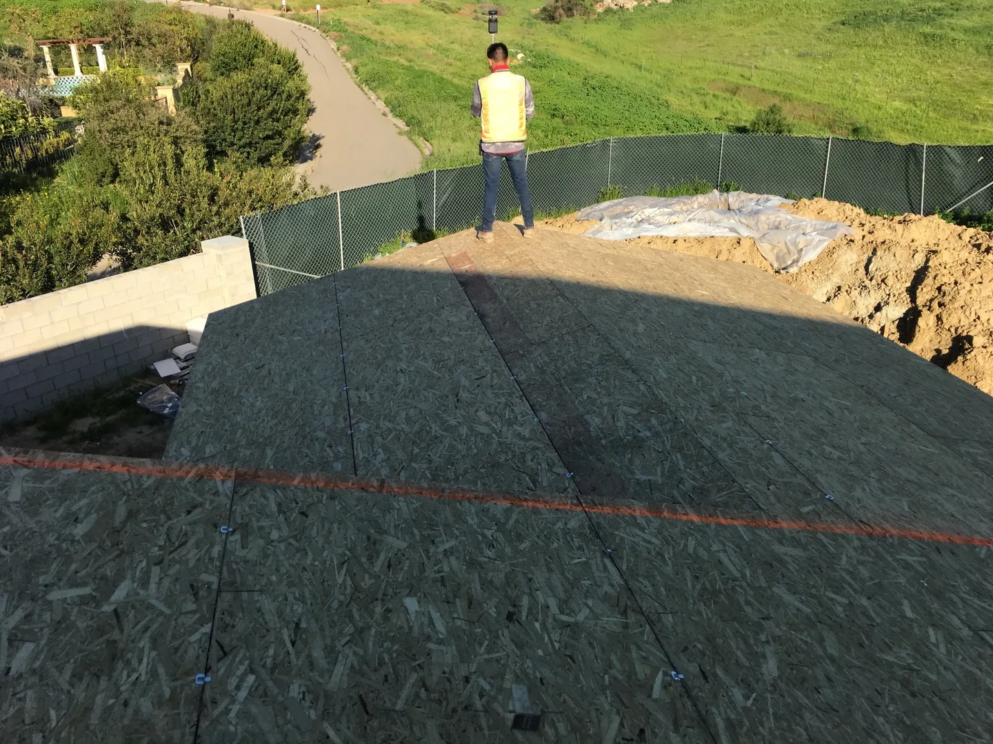 A man standing on top of the roof