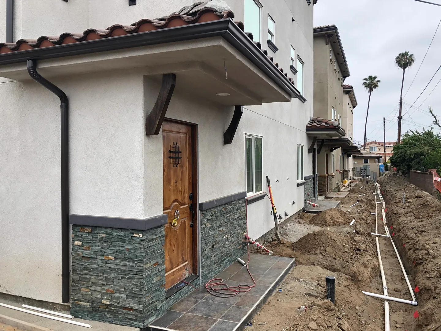 Drainage lines being laid behind houses