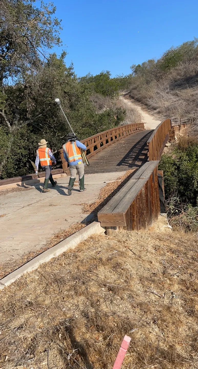 Two men walking towards the bridge